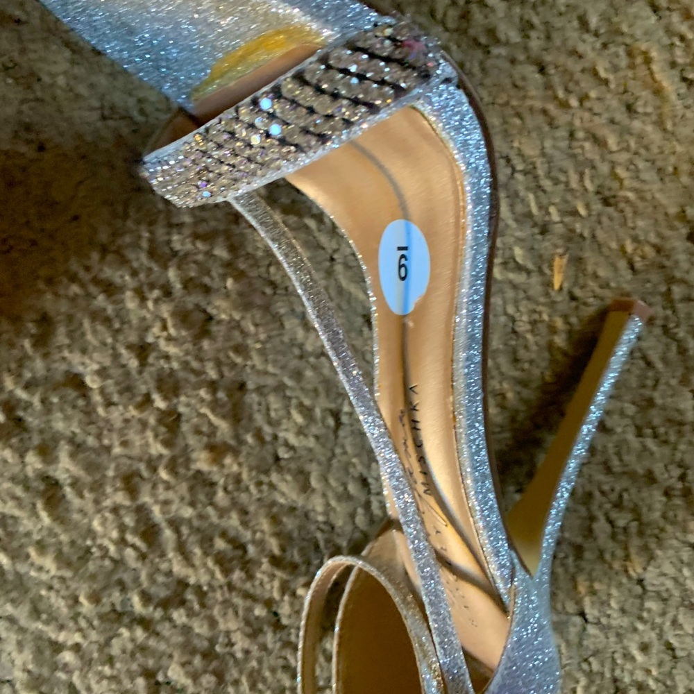 Silver, strappy, high-heeled sandal.